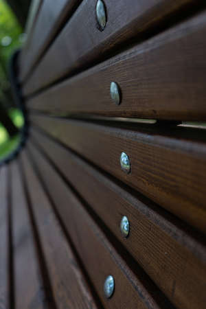 elements of the bench. Wooden slats with metal nails with round cap. Selective focus. bench in the city Parkの写真素材