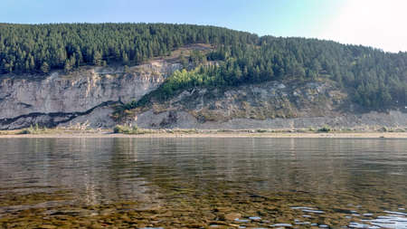 The Kirenga River, Kirensk, Siberia. Transparent northern river on the background of hills and rocks...