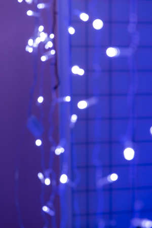Christmas lights at night. Blurred background. Festive concept. Space for copying. Bokeh, selective...