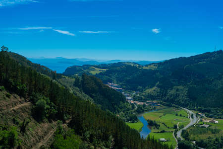 Top view of the mountain valley. Mountain landscape with a settlement belowの写真素材