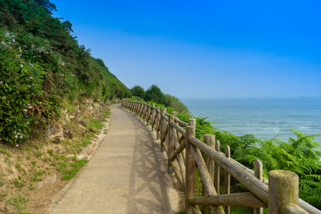 Hiking trail along the rocks and the ocean. Way of the Camino de Santiagoの写真素材