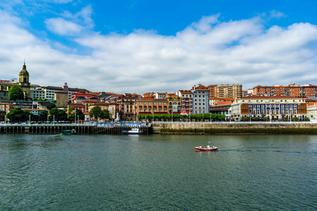Portugalete, Basque Country, Spain - 20.07.2022: View of Portugalete town by Nervion river, and Sandra Maria basilica, Basque Country, Spain.のeditorial素材