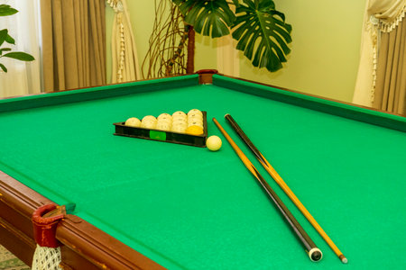 Billiard balls in a triangle and a cue on the table.の写真素材