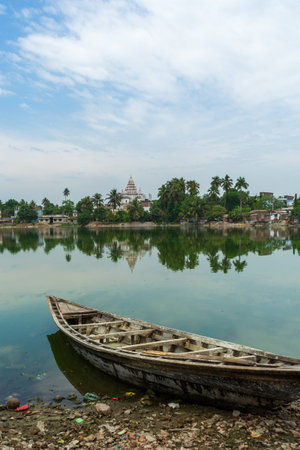 Traditional Bengali Wooden boat on pond bank Shiva Temple, at Puthia Rajbari complex, in Puthia, Bangladeshの写真素材