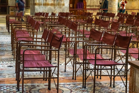 Folding chairs on an ornate marble floor in a historic church buildingの写真素材