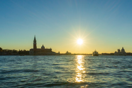 Venice sunset with San Giorgio Maggiore and golden reflectionsの写真素材