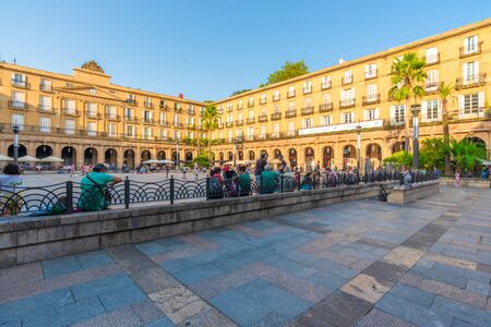 16/09-19, Bilbao, Spain. People and children enjoying the afternoon on Plaza Nueva. The Royal Academy of the Basque Language in the middle of the pictureの写真素材