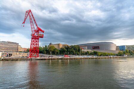 15/09-19, Bilbao, Spain. The crane, named La Carola, is a left over from the areas industrial past. The San MamÃ©s soccer stadium, home to Athletic Bilbao is seen to the right.の写真素材