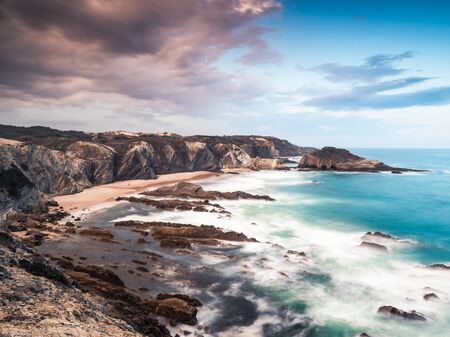 27/09-18, Zambujeira do Mar, Portugal. View over a beautiful sand beach. A storm is forming over land.の写真素材