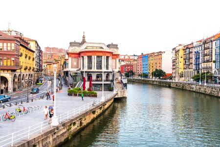 Bilbao, Spain - September 16, 2019. View of the Bilbao river, the historic market La Ribera and the street Erribera Kalea on the left.のeditorial素材