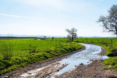 February 19, 2020 - Belianes-Preixana, Spain. A gravel road flooded by a leaking aquaduct.の写真素材