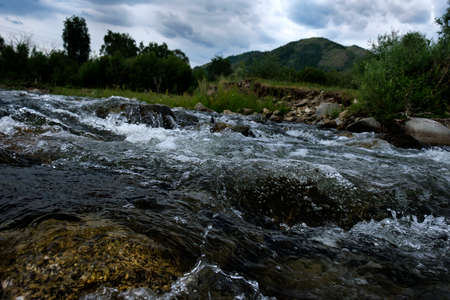 the rapid running of mountain rivers on a quiet summer evening on a long shutter speed