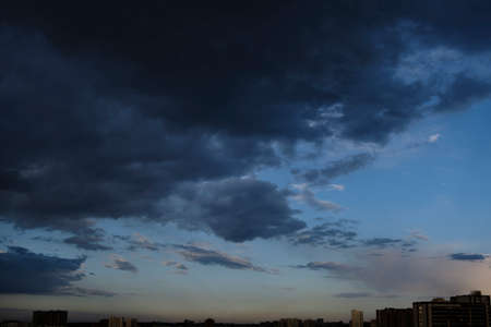 the boundless expansion of the sky with cumulus clouds and rays of the sun, moments of daybreak and sunset, fine time and bad weatherの写真素材