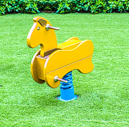 Yellow Rocking Horse on Yardの写真素材