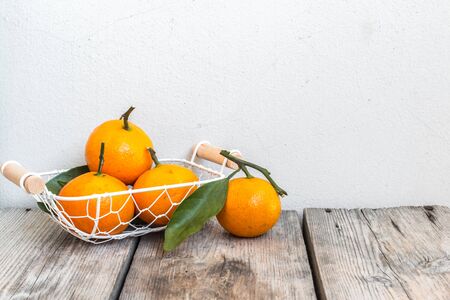 Four Oranges in Basket on a Tableの写真素材