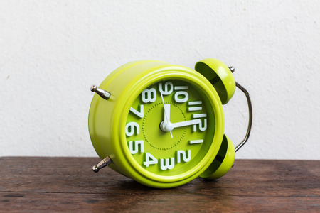 Alarm Clock at 9 O'clock on wood table