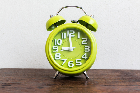 Alarm Clock at 9 O'clock on wood tableの写真素材