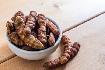Sweet Seedless Tamarind In White Bowl On Wood Tableの写真素材