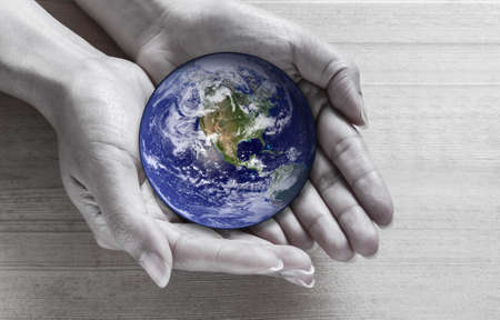Woman holding globe in hands の写真素材