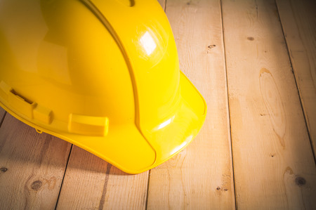 Yellow Safety Helmet on Wooden Floor , Vintage Styleの写真素材