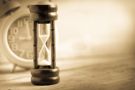 Close-up Hourglass on wood background , antique toneの写真素材
