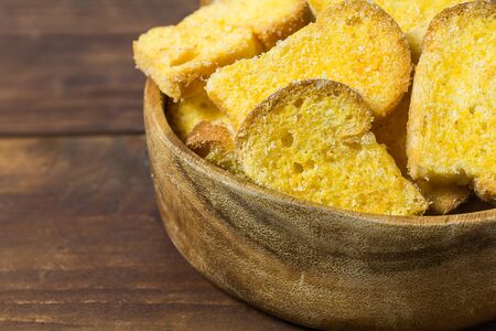 Close-up Crispy Bread in wood bowl on wood tableの写真素材