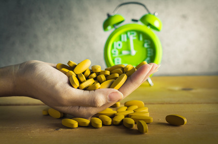 Handful of medicine on wood background , antique styeの写真素材