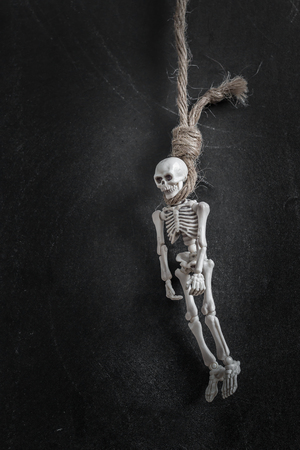 Hanged skelenton over black backbroundの写真素材