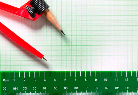 Drawing Compasses and Ruler on green graph paper with copy spaceの写真素材