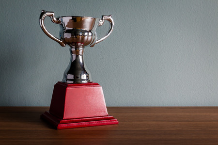 Still life with trophy on wood tableの写真素材