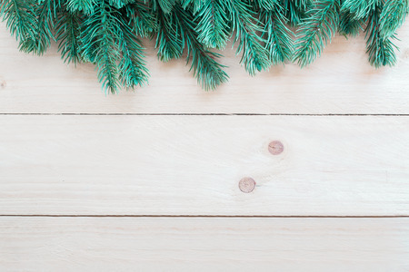 Christmas tree twigs of spruce on a wood background arranged in border patternの写真素材
