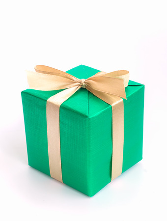 Green gift box with gold ribbon isolated on white backgroundの写真素材