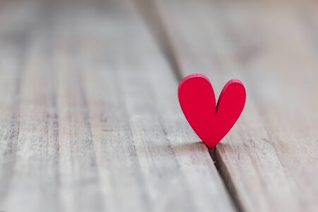 One red heart stands on wood table , Winner of love conceptの写真素材