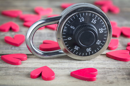 Combination padlock stands on amongst the heartsの写真素材