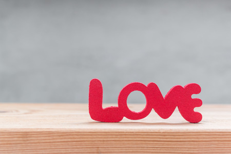 Words "Love" from wooden on wooden over grung cement backgroundの写真素材