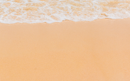 Wave of sea on the sand beach backgroundの写真素材