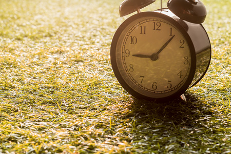 Vintage alarm clock on glass at morningの写真素材