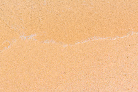 Wave of sea on the sand beach background