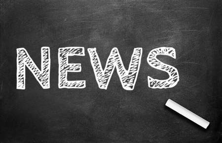 Chalk and news write on chalkboard backgroundの写真素材