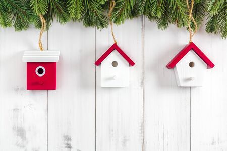 Christmas fir tree branches with home ornament on white rustic wooden background with copy space for textの写真素材