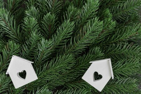 Wooden home ornament on fir tree branches backgroundの写真素材