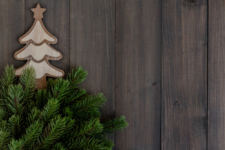 Christmas fir tree branches and tree ornament on dark rustic wooden background with copy space for textの写真素材