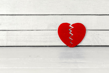 Brokend Heart over white wood backgroundの写真素材