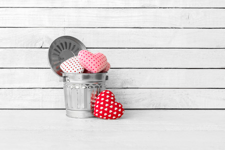 Red Heart Shaped made from fabric in bins over white wood backgroundの写真素材