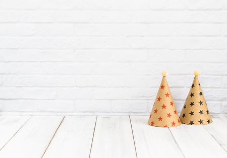 party hat on white wood table over white background with copy spaceの写真素材