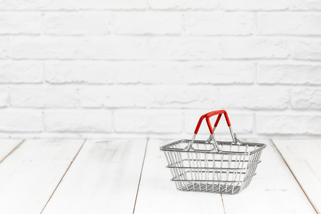 Basket on white wood background with copy space. shopping conceptの写真素材