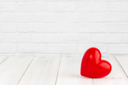 Red heart shaped on white wood background with copy spaceの写真素材