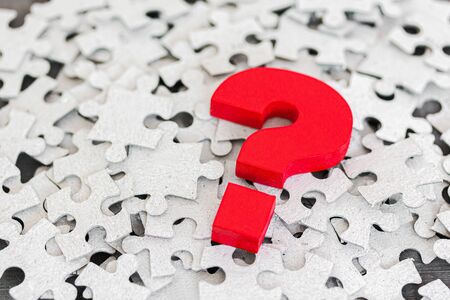 Red Question mark over group of puzzleの写真素材