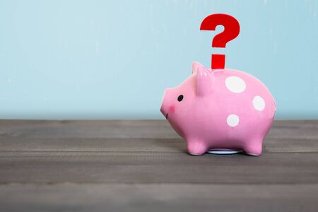 Question mark with piggy bank on wood table , Problem Conceptの写真素材