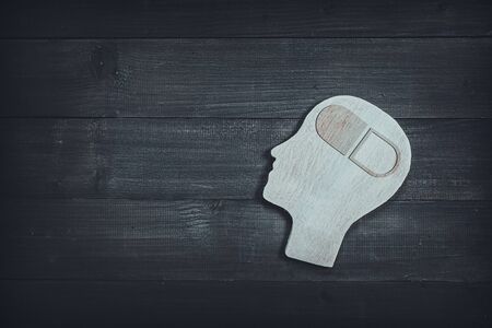 Human head and face with medicine sign on wood table background. Brain of thinking about health , Symbol of Process and Positive Mind conceptの写真素材